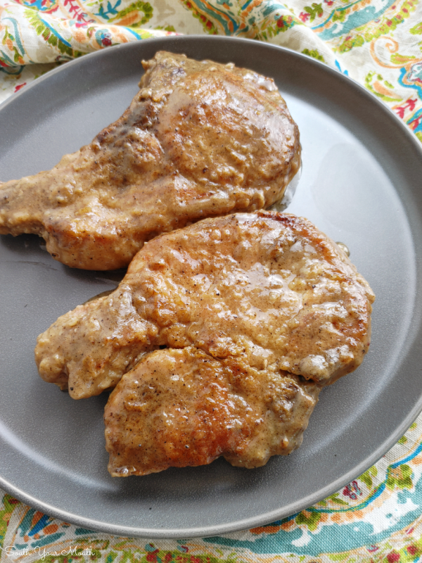 Smothered Pork Chops! A simple one-pan recipe for fork-tender pork chops smothered in gravy that thickens as the chops bake and tenderizes them low and slow in the oven.