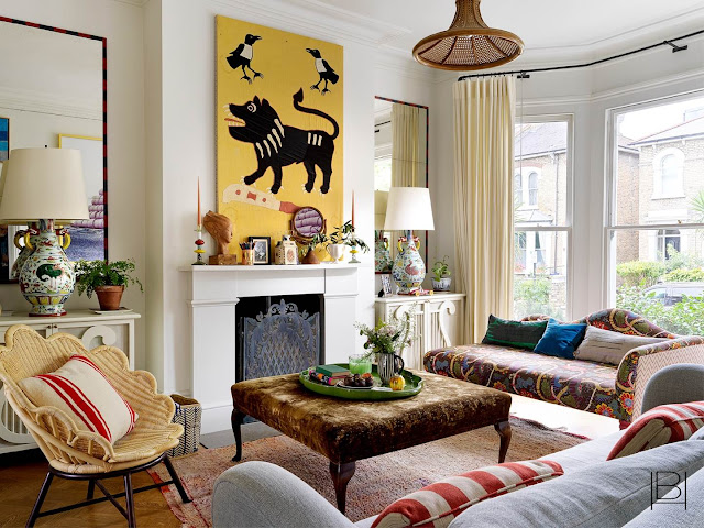 Beata Heuman living room with pattern mixing, rattan chair, and unique artwork