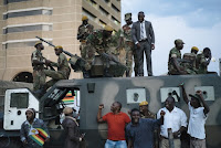 Civilians standing by members of the Zimbabwe Defense Forces in Harare