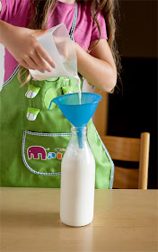 Homemade almond milk filling in bottle
