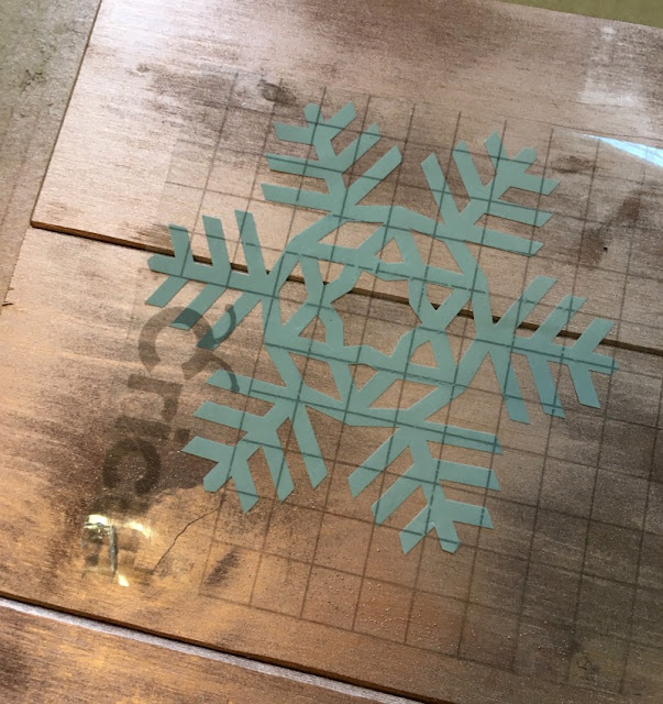 I used scrap wood, paint, and vinyl to make a Rustic Wooden Snowflake Sign.