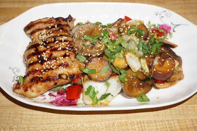 This recipe consists of skinless, boneless chicken thighs, seasoned with Chinese oyster sauce and grilled. Chicken thighs are served with Asian vegetables and sprinkled with roasted sesame seeds.