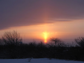 sun pillar with rising sun