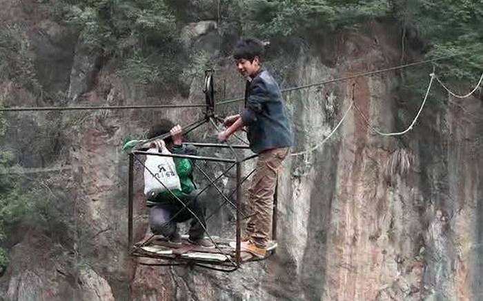 To get to school each day
                                  children living in a mountainous
                                  village in China have to cross a
                                  valley hundreds of metres deep on a
                                  rickety, homemade cable car. Villagers
                                  who live in Decun village in southwest
                                  China's Guizhou Province used to have
                                  to make the journey on foot, which
                                  took five hours, but in 2002 local man
                                  Hui Defang built a simple
                                  cableway.Picture: Quirky China News /
                                  Rex Features