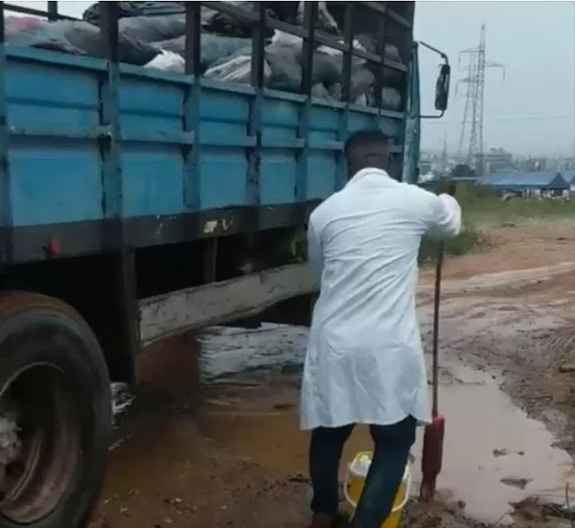 Hilarious Moment A Doctor Was Spotted Mopping The Muddy Ground After A Heavy Rain In Ghana