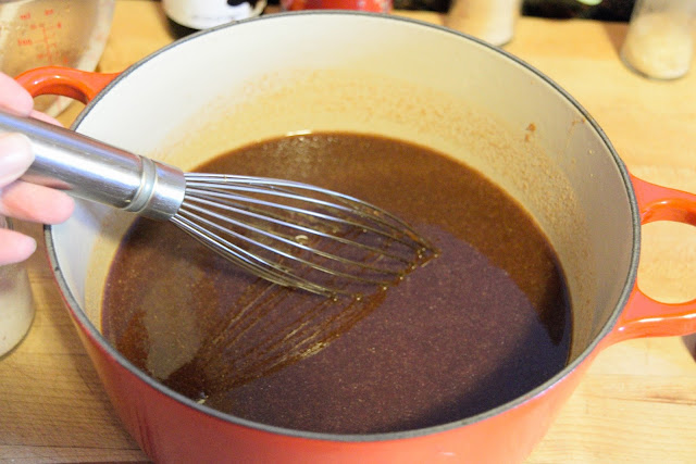 All the ingredients in the pot for the bbq sauce being whisked together.