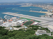 . a plane lands or departs. This is one amazing airport, just check out . (gibraltar airport)
