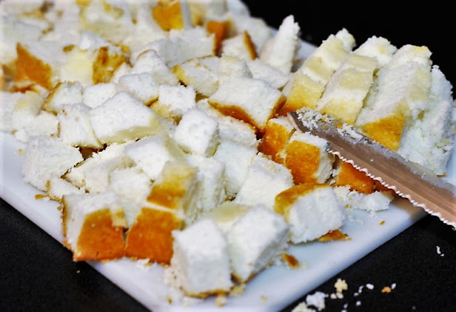 Cutting Angel Food Cake Cubes for Strawberry Punch Bowl Cake Image