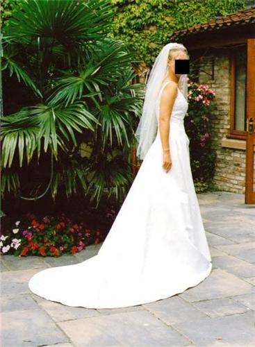 A stunning ivory bridal gown worn only once with a detailed vneck
