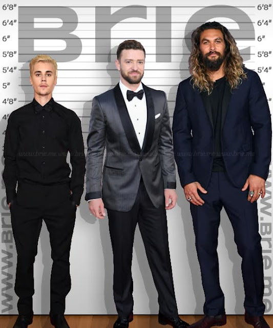 Justin Timberlake standing with Justin Bieber and Jason Momoa