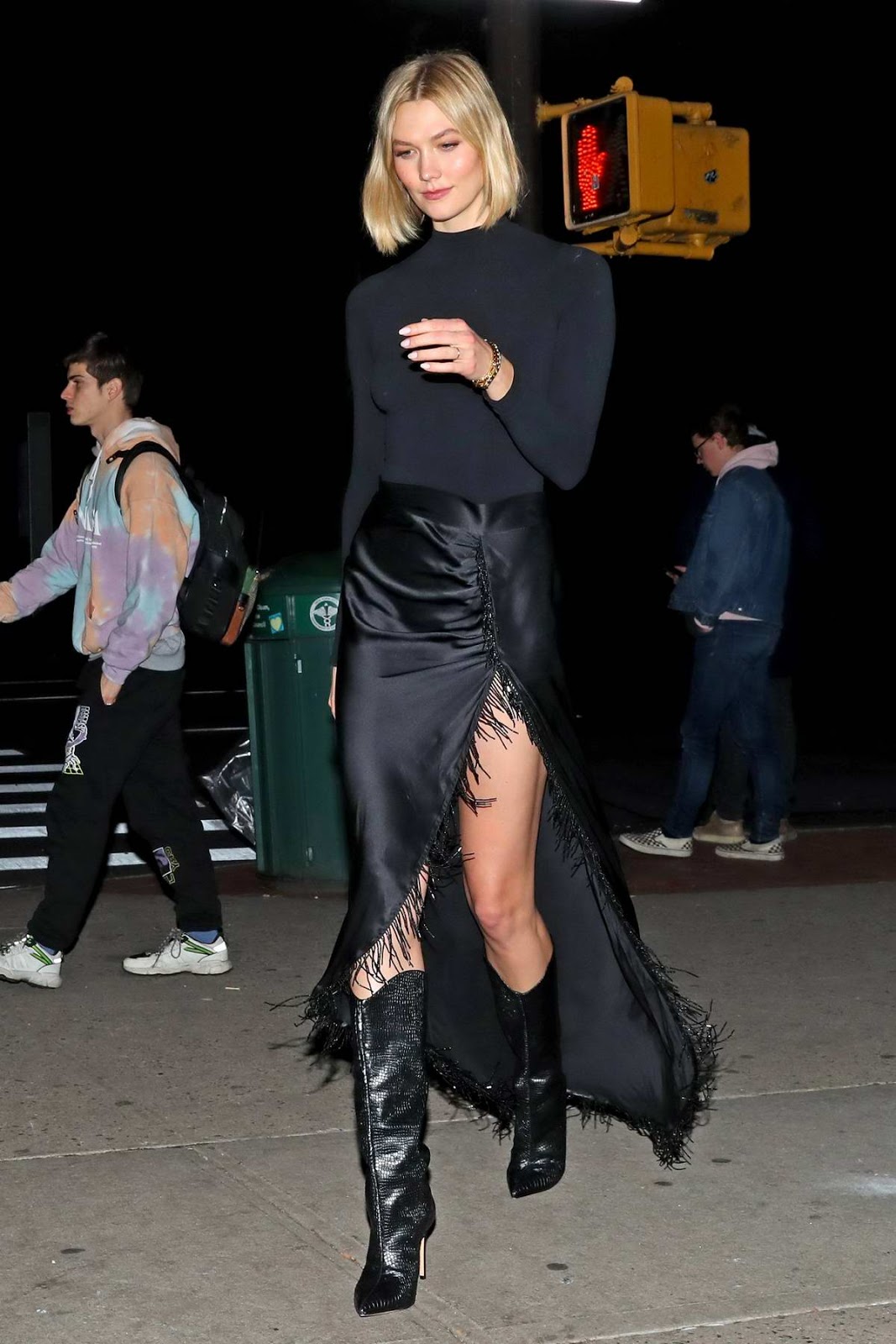 Karlie Kloss in a black turtleneck with a matching slit skirt as night out in New York City