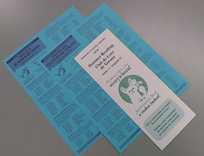 Blue fliers and a white folded brochure promoting Summer Reading activities at Sonoma County Library