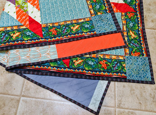 Folded quilt shows the front, back, and binding.