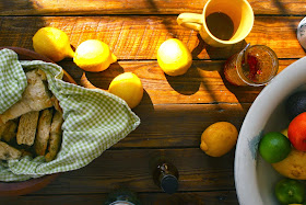 Lemons, Limes, Oranges and Grapefruit on Table with Biscuits and Jam