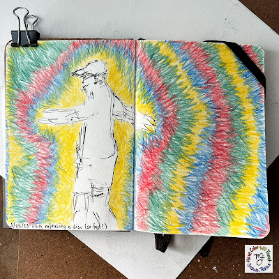 A full spread sketchbook page lies clipped open on a desk. Visible is a drawing of a young man in the process of throwing a disc golf disc. Around him is a vibrant halo of colored pencil colors.
