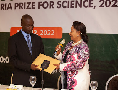 Prof Agbo receiving the entries from Chief Mrs Akande