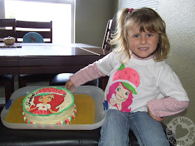 Girl in Strawberry Shortcake Applique T-Shirt with birthday cake