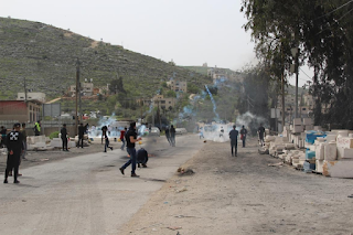 The occupation’s violations continue: a martyr, injuries, arrests, the closure of the entrances to Hebron and Tarqumiya, and the seizure of a lathe    Governorates  Wafa - Friday, the Israeli occupation soldiers and settlers continued their aggression against our people, their sanctities and property, as a martyr was martyred and a number of citizens were injured during confrontations with the occupation and the suppression of activities and attacks by settlers, and 16 citizens, including a girl and 3 brothers, were arrested. The occupation fired on shepherds in the central Gaza Strip, closed two entrances to the city of Hebron, and seized a lathe from the city.  Martyr and wounded during confrontations with the occupation and the suppression of activities   The 28-year-old Ahmed Younis Sidqi Al-Atrash was martyred after the Israeli occupation army shot him in the head, on Al-Shallala Street in the center of Hebron .  The martyr al-Atrash is a freed prisoner, and he spent nearly 9 years in the occupation prisons.   On the other hand, 12 civilians were injured by rubber-coated metal bullets, 3 by shrapnel from stun grenades and live bullets, and 57 civilians by suffocation with poisonous tear gas, during confrontations with the Israeli occupation forces and settlers in Qaryut village, south of Nablus.  And 13 injuries were recorded with rubber-coated metal bullets, 6 burns from tear gas canisters, 2 from falling, and 114 from suffocation with poisonous tear gas, during clashes that erupted near Jabal Sabih and at the entrance to the town of Beita, south of Nablus.  Also, a Red Crescent ambulance was hit by a metal bullet and hit its windshield, while one of the injured was evacuated from the Beta junction .  In the confrontations that took place with the occupation in the town of Beit Dajan to the east, a citizen was shot in the foot with live bullets, a journalist was hit with a stun grenade, and 25 civilians suffocated with tear gas.  Eight civilians were wounded by rubber-coated metal bullets, and dozens suffocated, during the Israeli occupation army’s suppression of the weekly march in the town of Kafr Qaddum, east of Qalqilya, which is organized to protest against the settlements and to demand the opening of the village road that has been closed for more than 17 years in favor of the “Qaddumim” settlement built on village lands .  Two young men were wounded by live bullets in their lower limbs, during confrontations with the occupation forces, after storming the village of Deir Ghassaneh, northwest of Ramallah .  A young man was also wounded by live bullets in his hand and foot, and dozens suffocated, during the suppression of a central march that took place in Bil'in village, west of Ramallah, in commemoration of the 46th anniversary of Land Day .  Following the storming of Al-Jalazun refugee camp near Ramallah, clashes erupted during which the occupation soldiers fired bullets, tear gas and sound bombs, as a result of which a young man was hit in the head by rubber bullets, and his condition was described as moderate .   Injuries in settler attacks in Jerusalem and Nablus  Young Ahmed Abu Khdeir (20 years), from the town of Shuafat in occupied Jerusalem, was injured and bruised after settlers severely beat him near a light rail station in the “French Hill” area in occupied Jerusalem.  On the other hand, settlers stormed the southwestern area of ​​Qaryut village, south of Nablus, under the protection of the Israeli occupation soldiers.  In a second violation, settlers prevented farmers from accessing their lands in the Rafid and Al-Mughrabat areas in the town of Sinjel, north of Ramallah, under the protection of the occupation forces.   16 citizens, including a girl and 3 brothers, were arrested  The Israeli occupation forces arrested a girl, whose identity was not known, while she was in the courtyards of Al-Aqsa Mosque, in occupied Jerusalem .  The occupation forces arrested 3 brothers from the town of Yamoun, west of Jenin. They are: Amir, Adel, and Ali Kamel Al-Jabari .  From Ramallah, forces arrested 5 citizens: Musharraf al-Rimawi, his son Laith, Yazan Jalal Abdul Rahim al-Rimawi from the town of Beit Rima in the north, Lafi Atef Abu Latifa from the roof of Marhaba Beer, and Muhammad Abu Kweik from al-Amari camp near Ramallah .  From Nablus, the occupation arrested 3 citizens, they are: Orhan Fathi Muhammad Hamayel, Amjad Salah Humaidan Hamayel, from the town of Beita, and Ahmad Haj Muhammad from the village of Telfit in the south .  The Bethlehem Governorate witnessed the arrest of the two young men: Muhammad Hassan Abu Srour from the town of Doha in the west, and Issam Muhammad Taqatqa from the town of Beit Fajjar in the south .  From the city of Hebron, the occupation forces arrested the young man Munther Al-Jubeh, while the young Mutassim Al-Badawi, from Al-Aroub camp in the north, was arrested.   Firing towards shepherds east of Maghazi, closing two entrances in Hebron, and seizing a lathe  The Israeli occupation forces, stationed in military towers in the east of Al Wusta Governorate, fired machine guns at shepherds, east of Al-Maghazi refugee camp, in the central Gaza Strip, forcing them to leave the area .  In another context, the occupation forces placed concrete cubes in the Al-Harayeq areas, at the southern entrance to Hebron, and the entrance to Tarqumiya, west of Hebron.  And a force of the occupation army stormed a lathe, after its doors were smashed and vandalized, in the industrial zone of Hebron city, and seized it.  The lathe is owned by Abu Mustafa al-Karak.