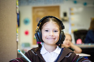 Young girl wearing noise canceling headphones