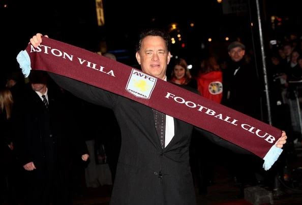 Actor Tom Hanks poses with an Aston Villa FC football supporters' scarf as he arrives to attend the European premiere of 'Charlie Wilson's War' at the Empire Cinema, Leicester Square on January 9, 2008 in London, England