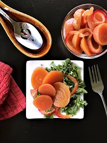 Pickled golden beets presented on a small plate.