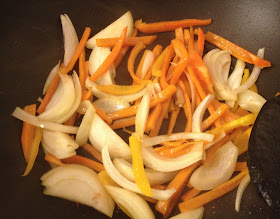 onion sweet peppers cooking in wok