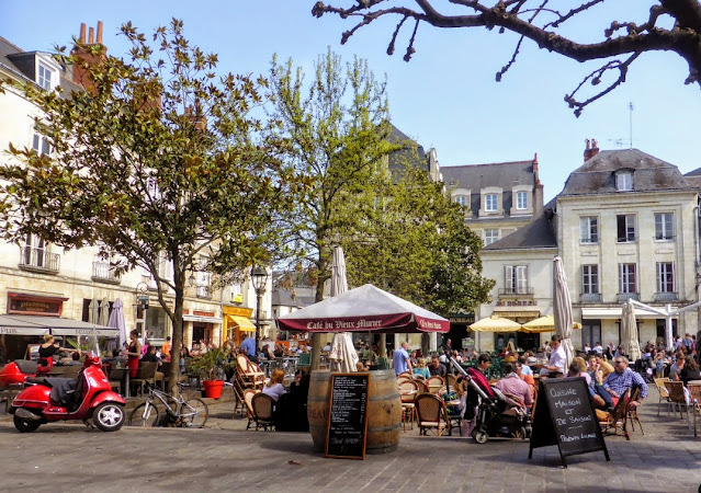 People sitting at tables in Place Plumereau, Tours  lovely in spring