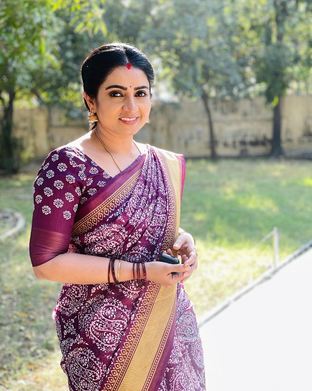 A girl's pic who is wearing red blouse with a black silk saree on Craiyon