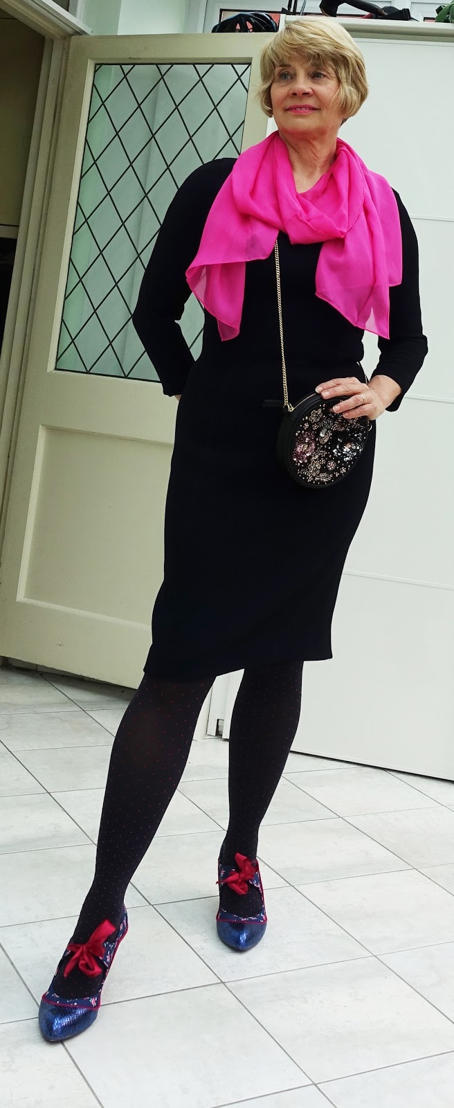 How to use accessories to transform a dull outfit, in this case a plain navy shift dress, Over 40s blog Is This Mutton? adds fuchsia pink and blue and a cute sequinned bag.