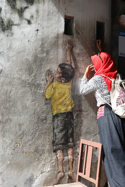 boy reaching up, mural street art Penang