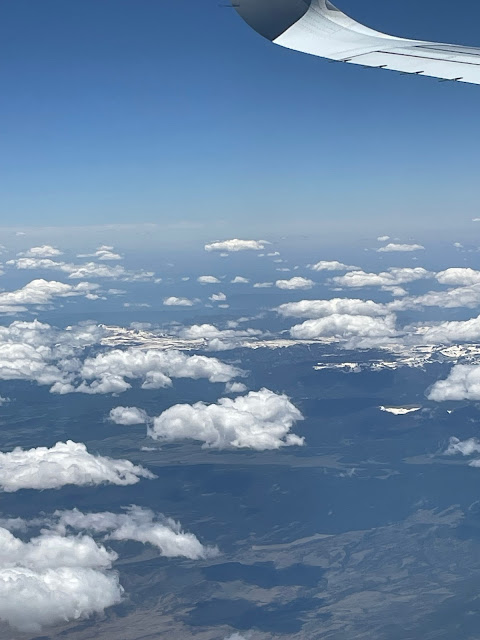 A picture while on the plane up in the air. We are above the clouds.