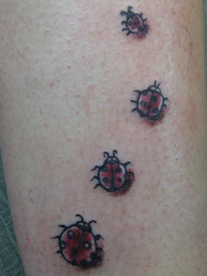 Trail of four ladybug tattoos