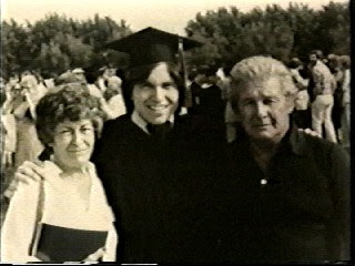 Mom & Dad with me at my college graduation.