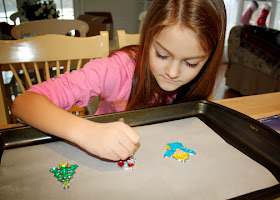 While not the absolute best example of how stained-glass windows are made, I thought these holiday Makit & Bakit ornaments fit the bill well enough for Tessa's age. She hadn't done any of these before, so it was a neat experience for her. Plus, it doubled as a holiday craft.