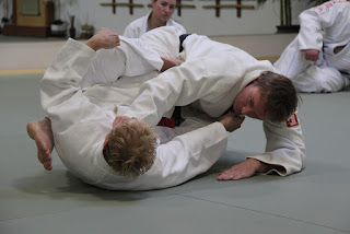 Two people grappling during martial arts in Ann Arbor