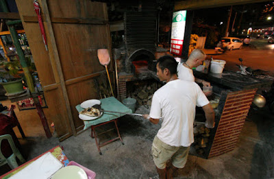 Preparing pizza at Thai Italy