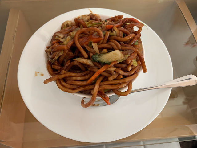 Bowl of vegetarian Shanghai fried noodles on a white plate