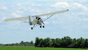 Belite Tricycle Gear Ultralight Aircraft takes off (bird dog pic )