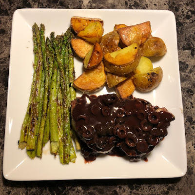 Grilled lamb loin chops topped with olive and red wine reduction, grilled asparagus and oven roasted Yukon gold potatoes