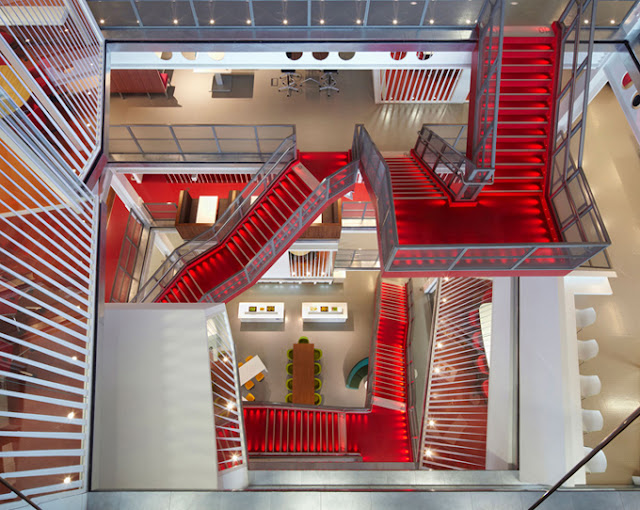 Photo of an office lobby with red staircase