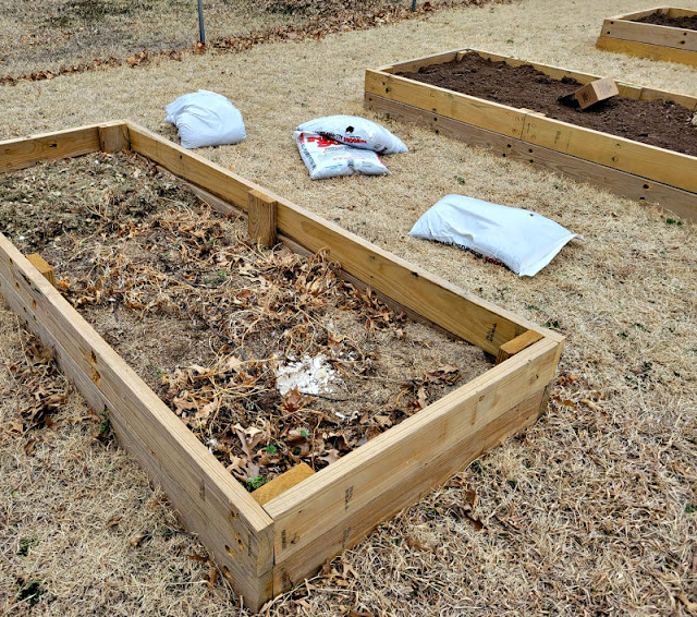 Filling a raised bed with soil, leaves, compost and more.