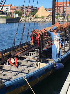 Woman in Medieval costume aboard Viking ship