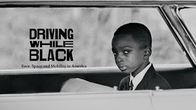 Driving While Black logo on photograph of young black boy in car