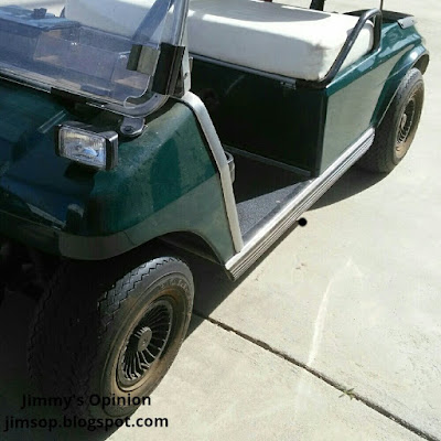 Side view of a green golf cart.