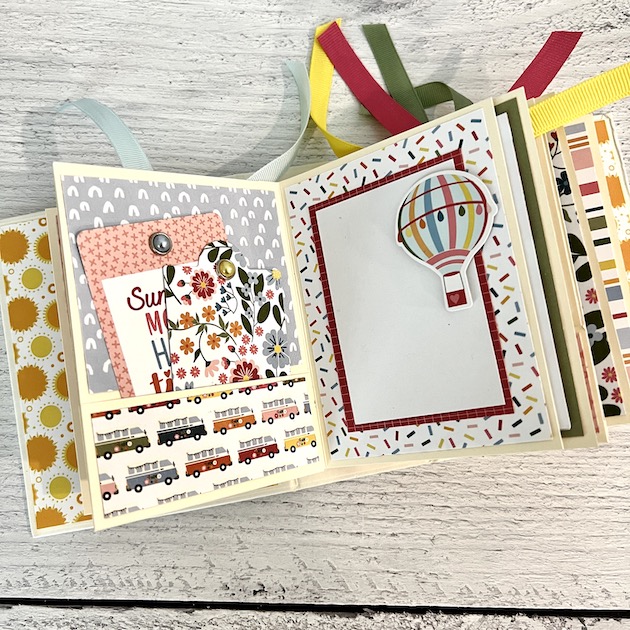 Summer Scrapbook Mini Album Page with flowers, a hot air balloon, pockets, & tags