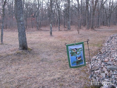 Brown yard with a Chickadee flag