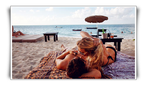 a picture of a bali gigolo with his female client at the beach