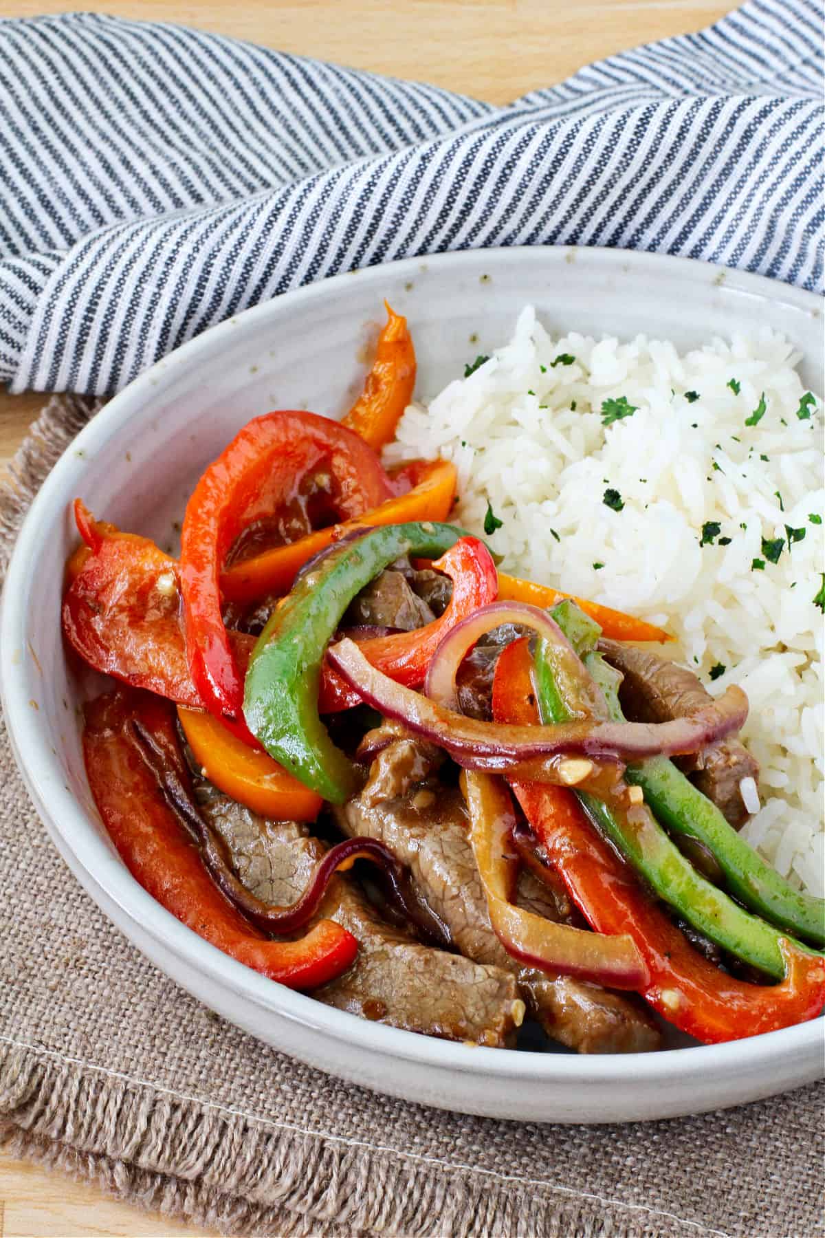 Hot Pepper Beef Stir-Fry in a bowl with rice on the side.