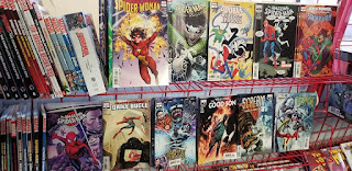 Spider Man comics on a red wire shelf at Acme Comics in Sioux City