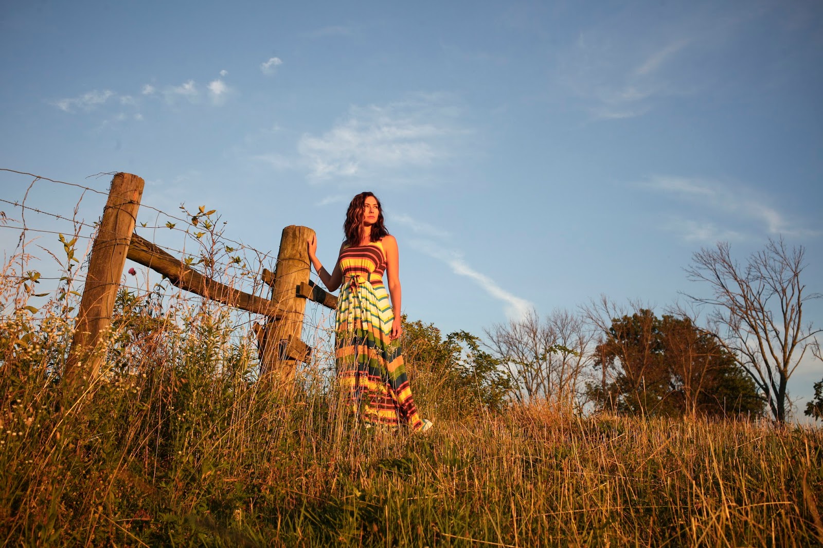 Amy West watches the sun set in this striped maxi dress on a farm in Kentucky